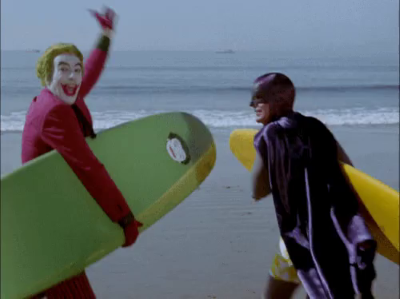 Batman and Joker are surfing together